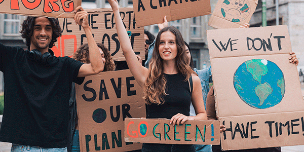 Climate activist holding up signs