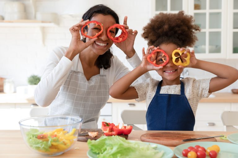 Parent and child having fun in kitchen